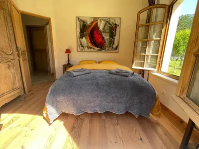 a bedroom with a bed with a blanket on it at Charmante bergerie dans un cadre bucolique in Saint-Rémy-de-Provence