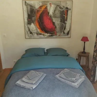 a bedroom with a bed with two towels on it at Charmante bergerie dans un cadre bucolique in Saint-Rémy-de-Provence