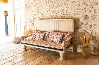 a bed in a room with a wall at Maison Bournissac in Noves
