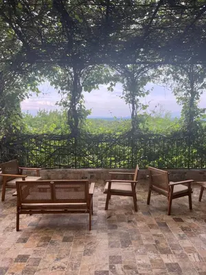 a group of benches sitting in front of a tree at Maison Bournissac in Noves
