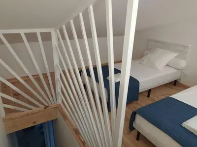 a small room with a bed and a staircase at Le Petit Pied à Terre du Luberon in Mérindol