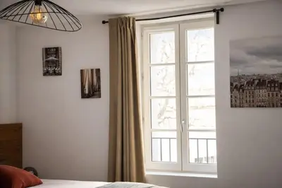 a window in a bedroom with a bed and a window at SOUS LES PLATANES in Velaux