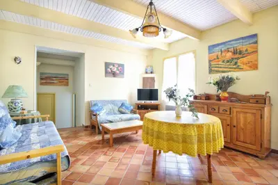 a living room with a table and a couch at La Cerisaie, maison spacieuse en Lubéron in Saint-Martin-de-Castillon