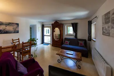 a living room with a couch and a table at Gites Provence et Nature - Ambiance familiale et conviviale en Luberon in Cabrières-dʼAvignon