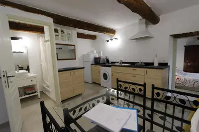 a kitchen with a table and a sink and a stove at Gites Provence et Nature - Ambiance familiale et conviviale en Luberon in Cabrières-dʼAvignon