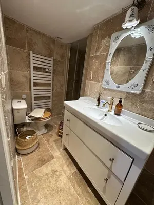 a bathroom with a white sink and a mirror at Duplex Atelier / coeur de Lourmarin in Lourmarin