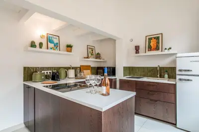 a kitchen with a counter with wine glasses on it at Appartement Cezanne - Welkeys in Aix-en-Provence