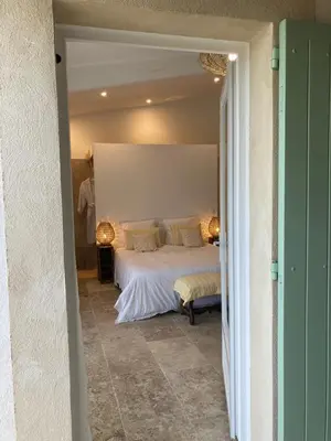 a bedroom with a large bed in a room at Chambre d'hôtes de la cime in Cabrières-dʼAigues