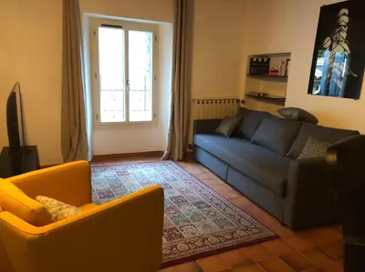 a living room with two couches and a window at Maison de caractère au coeur de la Provence in Robion en Luberon