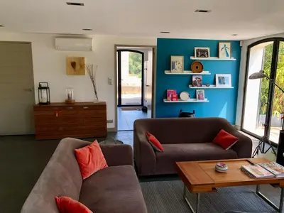 a living room with a couch and a table at Maison contemporaine dans le village d'Eygalières in Eygalières