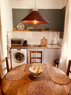a bedroom with a bed and a table and chairs at Appartement de charme au coeur du vieux Aix. in Aix-en-Provence