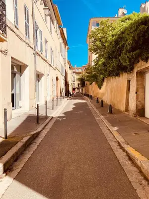 an empty street in a city with buildings at Appartement de charme au coeur du vieux Aix. in Aix-en-Provence