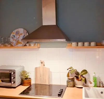 a kitchen with a stove top and a microwave at Appartement de charme au coeur du vieux Aix. in Aix-en-Provence