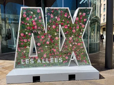 a flower arrangement in the shape of a letter with flowers at Aix Homes 