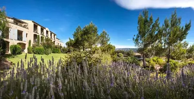 a garden with purple flowers in front of a building at Village Pont Royal en Provence - maeva Home - Appartement cosy et climatisé 2 pièces 5 personnes avec jardin - Prestige - super Home MAE-2864 in Mallemort