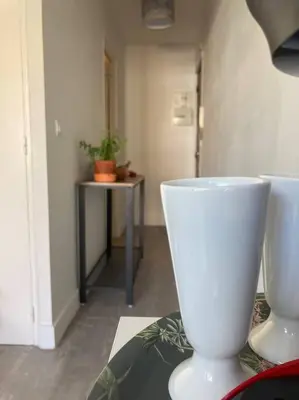 a room with two white vases on a table at Cozy Studio with balcony and free parking in Aix-en-Provence