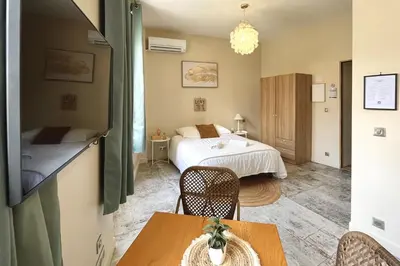 a hotel room with a bed and a table at Le Château Olive et Raisin in Fontaine-de-Vaucluse