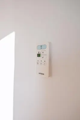 a white remote control on a white wall at La Blanchère, vue golf in Vedène