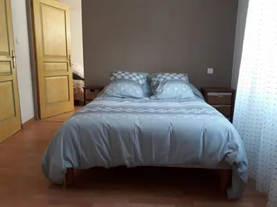 a bed with blue pillows in a bedroom at Apt en Luberon appartement 3 chambres et garage privée in Apt