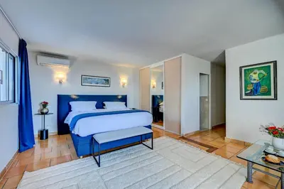 a bedroom with a blue bed in a room at The View Aix-en-Provence in Aix-en-Provence
