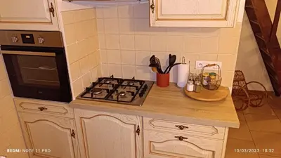 a kitchen counter with a stove and a microwave at L' ecurie de Florent et Spa in Cheval-Blanc