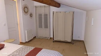 a bedroom with a bed and two shower stalls at L' ecurie de Florent et Spa in Cheval-Blanc