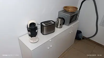 a kitchen counter with a microwave and appliances on it at L' ecurie de Florent et Spa in Cheval-Blanc