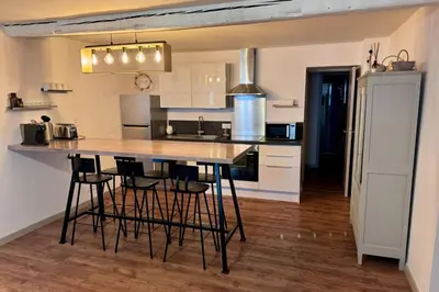 a kitchen with a table and chairs in a room at 