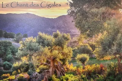 a painting of a field with trees and mountains at 