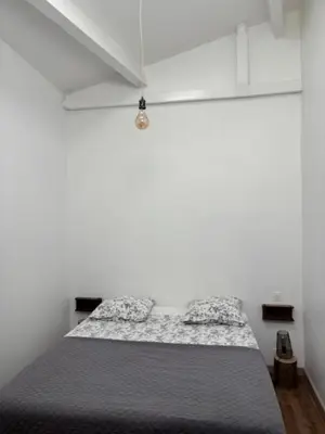 a bedroom with white walls and a large bed at 