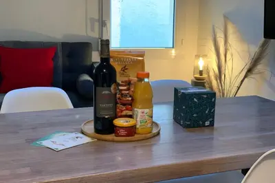 a table with two bottles of wine and condiments at 