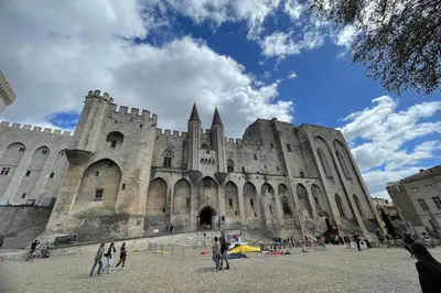 a large building with people standing in front of it at Under the Provençal Sun in LʼIsle-sur-la-Sorgue