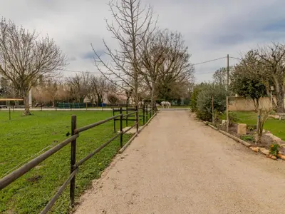 a dirt road with a fence next to a field at Apartment L'Aquillon by Interhome in Noves