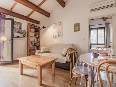 a living room with a couch and a table at Apartment L'Aquillon by Interhome in Noves
