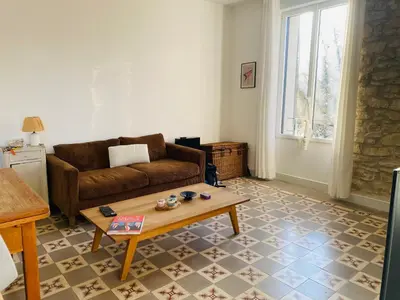 a living room with a couch and a coffee table at Gîte Mas La Bohème Piscine Parking Privé L'Isle-Sur-La-Sorgue in LʼIsle-sur-la-Sorgue