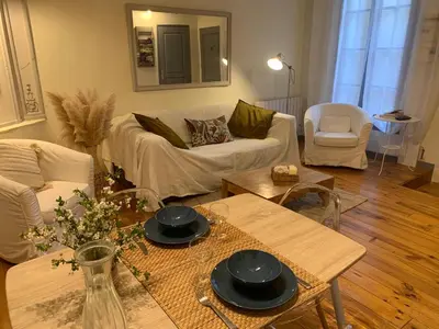 a living room with a couch and a table at Lou Magnan in LʼIsle-sur-la-Sorgue