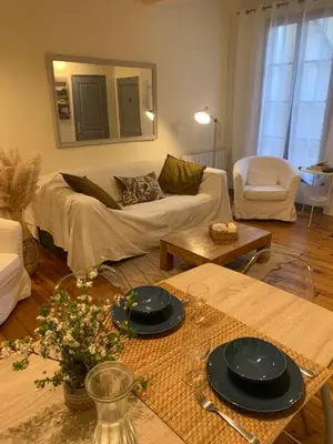a living room with a couch and a table at Lou Magnan in LʼIsle-sur-la-Sorgue