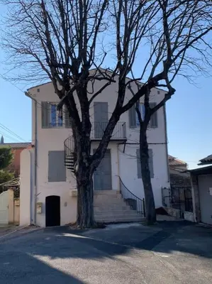 a white house with two trees in front of it at Joli studio centre village in Lambesc