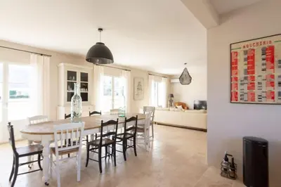 a kitchen and dining room with a table and chairs at Bastide la Melonnerie in Lacoste