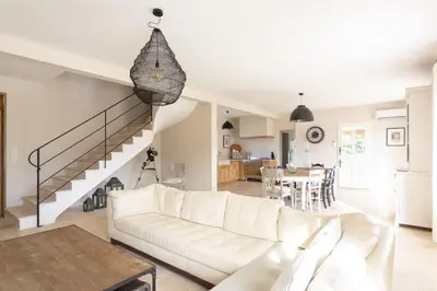 a living room with a white couch and a table at Bastide la Melonnerie in Lacoste