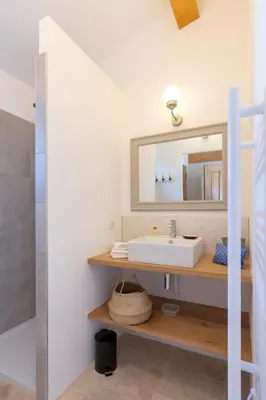 a bathroom with a sink and a mirror at Bastide la Melonnerie in Lacoste