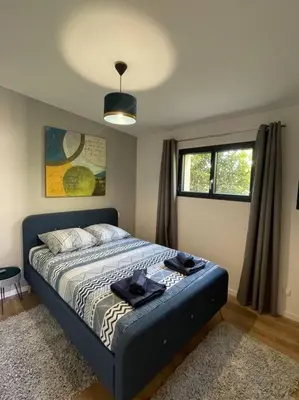 a bedroom with a bed with towels on it at Logement entier avec jacuzzi en provence in Le Thor