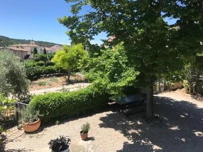a white car parked in front of a house at La Reynière du Sud Luberon in La Bastide-des-Jourdans