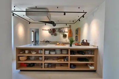 a kitchen with a shelf with pots and pans at Le Pavadou B&B in Méthamis