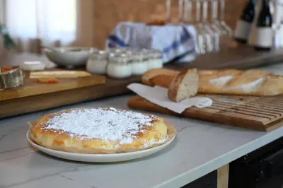 a pastry on a plate on a counter with bread at Le Pavadou B&B in Méthamis