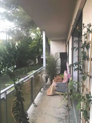 a balcony of a house with a cat sitting on it at Les Cerisiers. in Aix-en-Provence