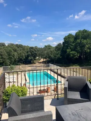 a view of a swimming pool from a balcony at La bastide des Roman in Vernègues