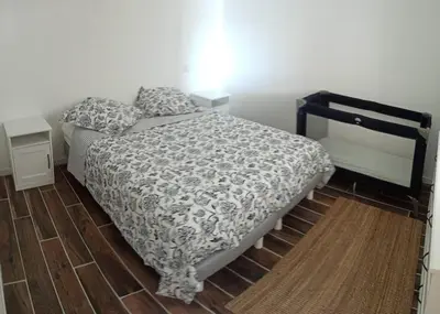 a bedroom with a bed with a black and white comforter at La bastide des Roman in Vernègues