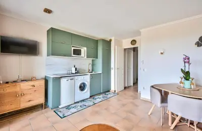 a kitchen with a washing machine and a table at Village Pont Royal en Provence - maeva Home - Appartement charmant et climatisé 2 pièces 4 personnes - Prestige - super Home MAE-4884 in Mallemort
