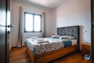 a bedroom with a large bed with a large window at Villa Moderne avec Jacuzzi proche d'Avignon in Le Thor
